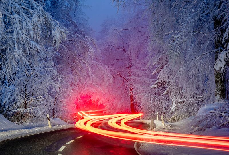 Long time exposure photo shows cars driving through a forest of the Taunus region near Frankfurt, Germany. AP Photo