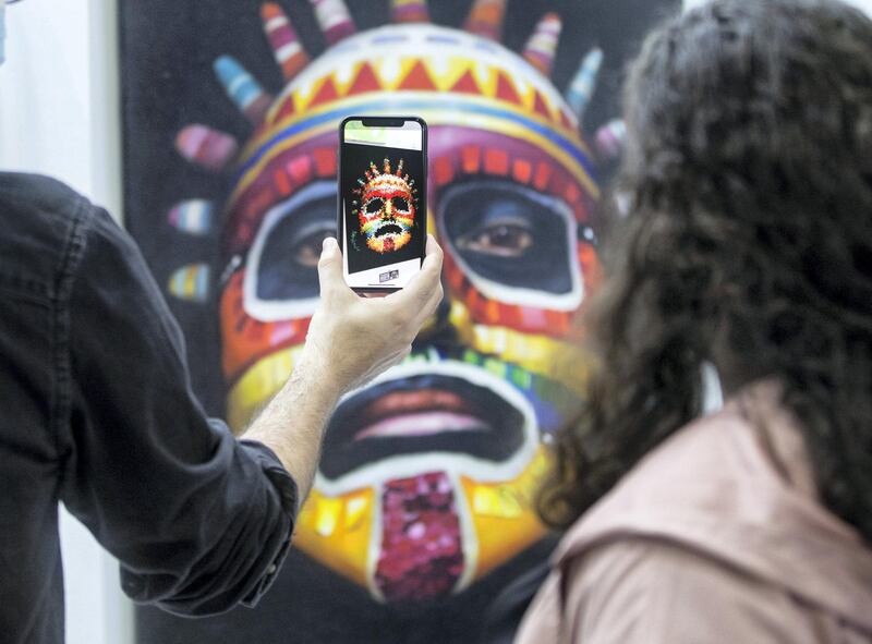 Dubai, United Arab Emirates - Artist Coco Valdez with his augmented artworks at the World Art Dubai at Dubai World Trade Centre.  Leslie Pableo for The National for Razmig's story