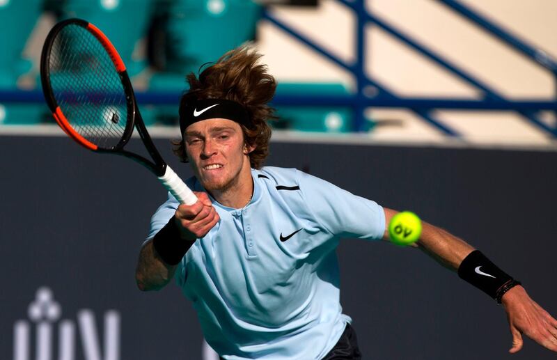 Russia's Andrey Rublev returns the ball to Spain's Pablo Carreno Busta during the 5th place tennis match at the Mubadala World Tennis Championship in Abu Dhabi on December 29, 2017. / AFP PHOTO / NEZAR BALOUT
