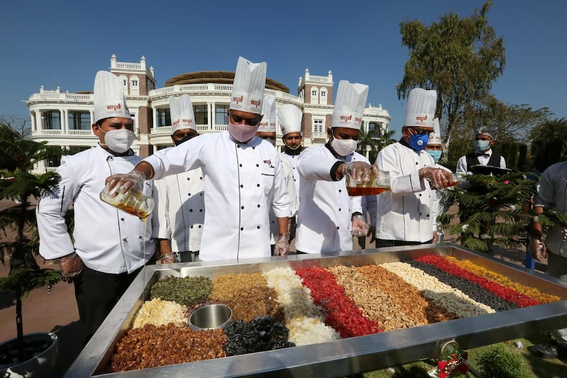 Chefs at the annual event of mixing dry fruits in brandy for Christmas cakes, in Bhopal, Madhya Pradesh, India, December 7. EPA