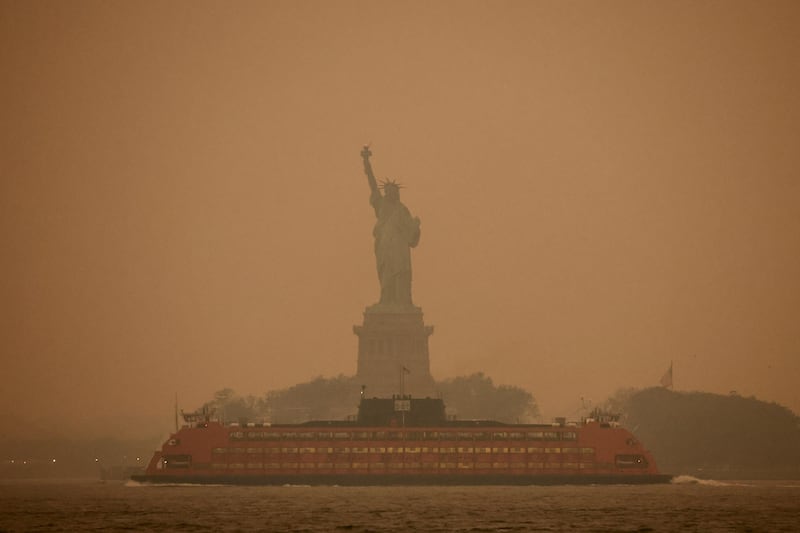 The Statue of Liberty is covered in haze and smoke caused by wildfires in Canada. Reuters