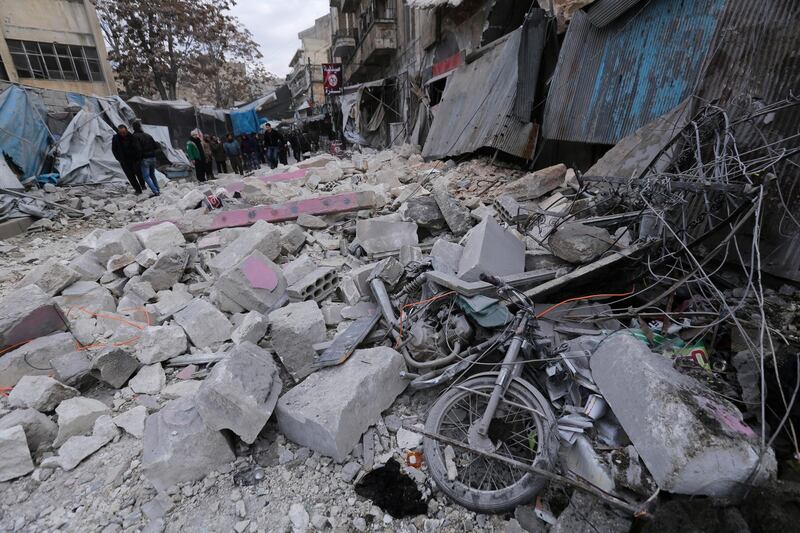 People look at destruction by the government airstrikes in the town of Ariha. AP Photo
