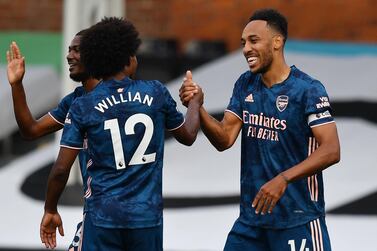 Arsenal's Pierre-Emerick Aubameyang (right) celebrates scoring his side's third goal of the game with da Silva Willian during the Premier League match at Craven Cottage, London. PA Photo. Picture date: Saturday September 12, 2020. See PA story SOCCER Fulham. Photo credit should read: Ben Stanstall/NMC Pool/PA Wire. EDITORIAL USE ONLY No use with unauthorised audio, video, data, fixture lists, club/league logos or "live" services. Online in-match use limited to 120 images, no video emulation. No use in betting, games or single club/league/player publications.