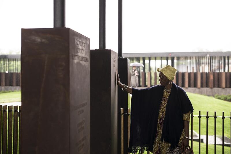 MONTGOMERY, AL - APRIL 26: Wretha Hudson, 73, discovers a marker commemorating lynchings in Lee County, Texas while visiting the National Memorial For Peace And Justice on April 26, 2018 in Montgomery, Alabama. Hudson, whose father's family came to Alabama from Lee County decades earlier, said the experience was overwhelming. "It's a combination of pride and strength, for my people. In our culture, rain is a sign of acceptance from our ancestors. So the rain is a sign of their acceptance for this day." The memorial is dedicated to the legacy of enslaved black people and those terrorized by lynching and Jim Crow segregation in America. Conceived by the Equal Justice Initiative, the physical environment is intended to foster reflection on America's history of racial inequality.   Bob Miller/Getty Images/AFP