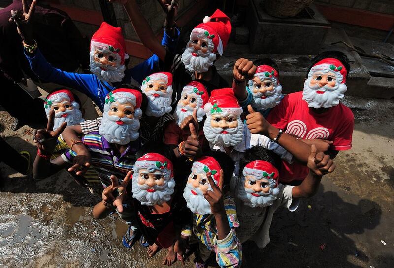 Children wear Santa Claus masks during Christmas eve celebrations in Bangalore, India.  Jagadeesh NV / EPA