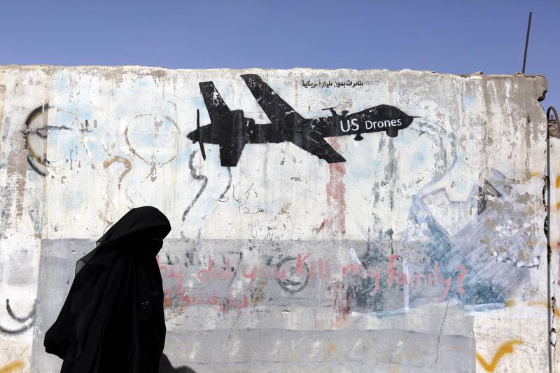 epa07419300 (FILE) - A Yemeni woman walks past a graffiti depicting a US drone, after alleged US drone raids killed dozens of Islamic State (IS) fighters, in Sana'a, Yemen, 17 October 2017 (reissued 07 March 2019). US President Trump signed an executive order on 06 March 2019, ending an Obama-era policy requiring US intelligence officials to publish the number of people killed in targeted strikes. US drone strikes have been used in countries such as Yemen and Somalia, designated by the US as areas of 'active hostilities.'  EPA/YAHYA ARHAB *** Local Caption *** 53836553