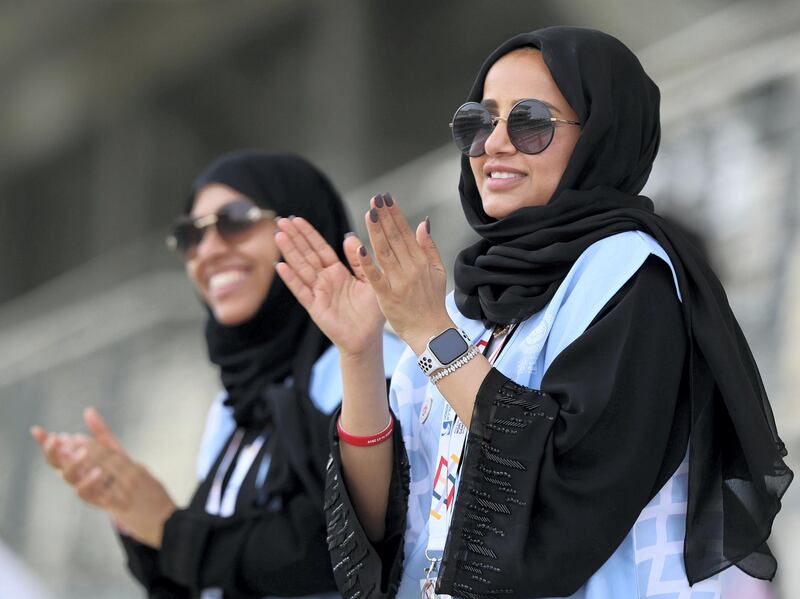 Abu Dhabi, United Arab Emirates - March 17, 2019: Volunteers cheer on the athletes during the 5km time trial during the cycling at the Special Olympics. Sunday the 17th of March 2019 Yas Marina Circuit, Abu Dhabi. Chris Whiteoak / The National