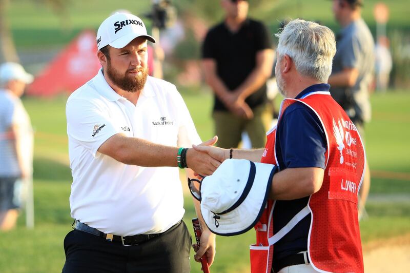 ABU DHABI, UNITED ARAB EMIRATES - JANUARY 17: Shane Lowry of Ireland shakes hands with caddie Brian "Bo" Martin on the 18th green during Day Two of the Abu Dhabi HSBC Golf Championship at Abu Dhabi Golf Club on January 17, 2019 in Abu Dhabi, United Arab Emirates. (Photo by Andrew Redington/Getty Images)
