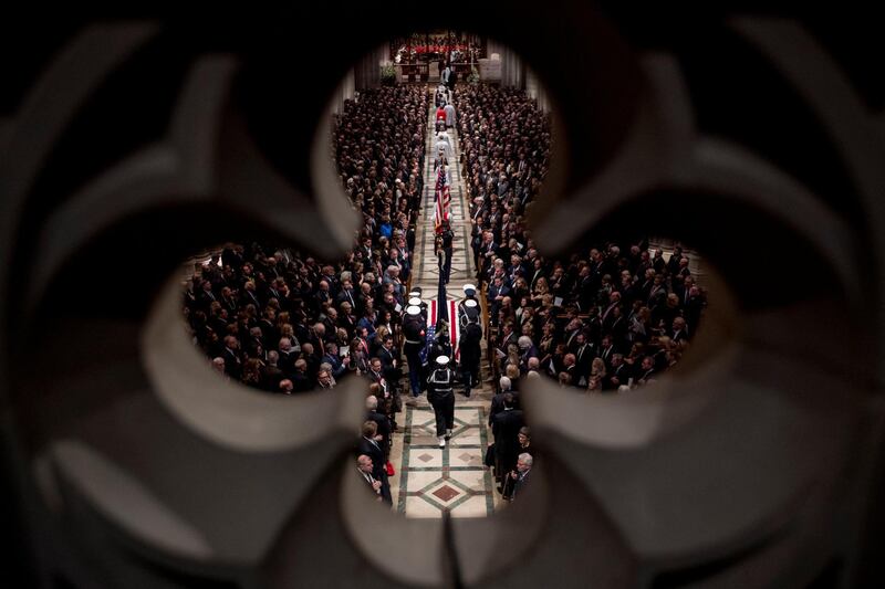 The flag-draped casket of former President George H.W. Bush is carried by a military honor guard during a State Funeral at the National Cathedral in Washington, DC. Reuters
