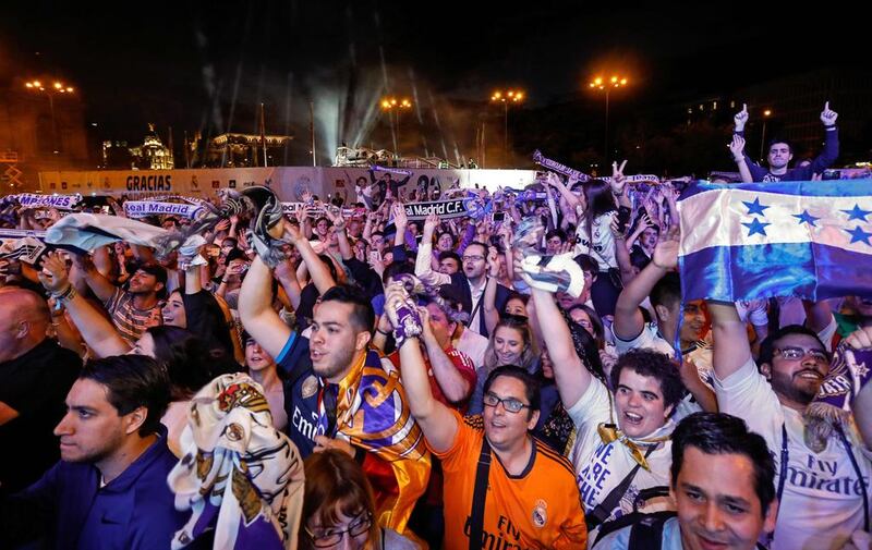 Real Madrid fans celebrate the team’s win on Plaza Cibeles in Madrid on May 21, 2017. Oscar del Pozo / AFP