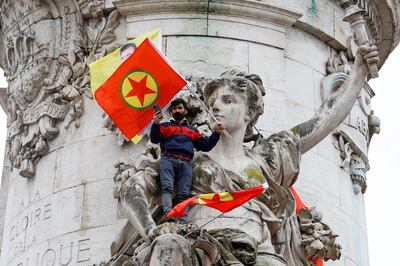 A man holds a PKK flag at a protest in Paris on Saturday. Reuters 
