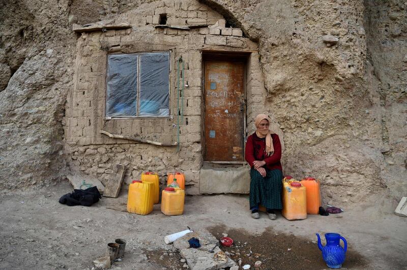 A Hazara woman sits at the entrance of a cave where she lives with her family at Tak Darakht village on the outskirts of Bamiyan province, Afghanistan. AFP