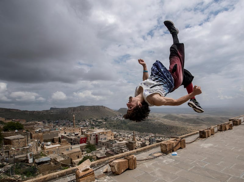 epaselect epa06732801 A participant in action during the Freerunning and Parkour World  Series in old city of Mardin east Turkey, 13 May 2018. According to media reports, more than 50 athletes are taking part in the Freerunning and Parkour World Series running between 12 and 13 May in the Turkish province of Mardin.  EPA/SEDAT SUNA