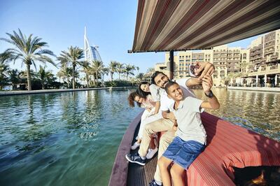 Tourists take an Abra ride through Dubai's Madinat Jumeirah resort. Image courtesy of Dubai Tourism.
