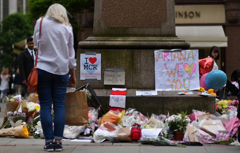 Mourners place flowers and other tributes in Albert Square, Manchester, to commemorate a bombing at an Ariana Grande concert in the city in 2017. AFP