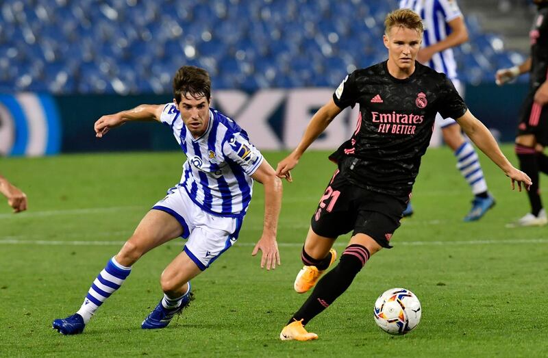 Real Madrid midfielder Martin Odegaard fights for the ball against Real Sociedad's Aritz Elustondo. AP Photo