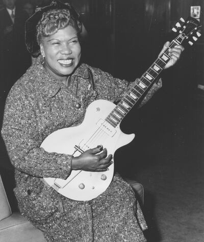 FILE- In this Nov. 21, 1957, file photo, Sister Rosetta Tharpe, guitar-playing American gospel singer, gives an inpromptu performance in a lounge at London Airport, following her arrival from New York. Tharpe, who died in 1973, will be inducted with the â€œAward for Early Influence" to the Rock and Roll Hall of Fame on April 14, 2018 in Cleveland, Ohio. (AP Photo, File)
