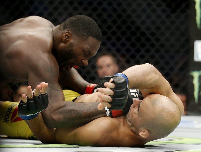 Anthony Johnson, left, punches Glover Teixeira during their light heavyweight bout at UFC 202. AP