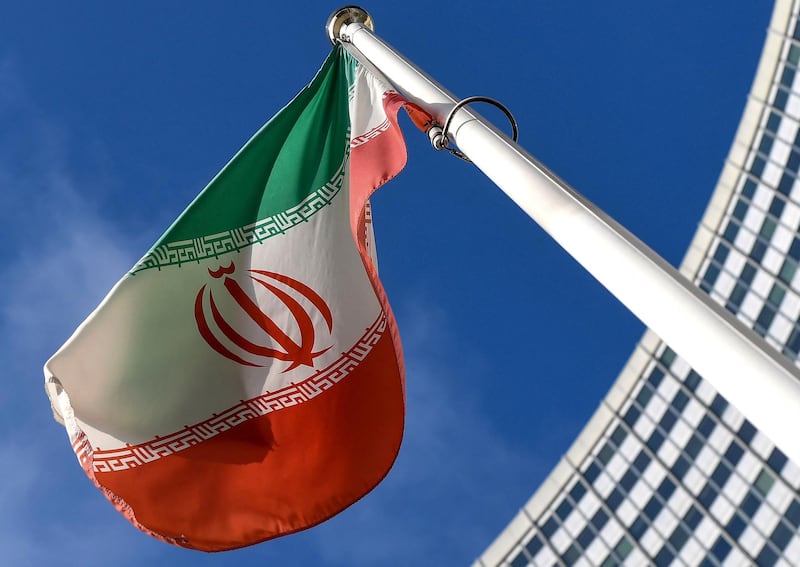 The Iranian national flag is seen outside the International Atomic Energy Agency (IAEA) headquarters during the agency's Board of Governors meeting in Vienna on March 1, 2021. / AFP / JOE KLAMAR
