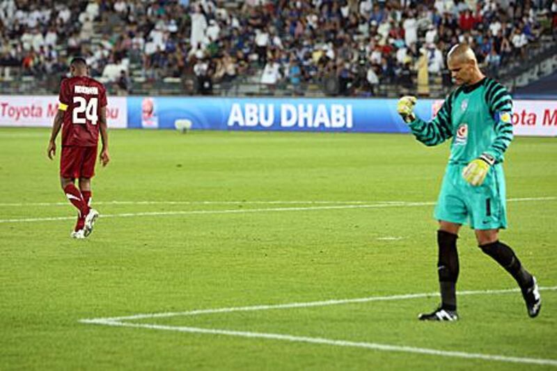 Al Wahda’s Abdulraheem Jumaa walks off after missing his penalty kick, while Miguel Caleroi, the Pachuca goalkeeper, celebrates.