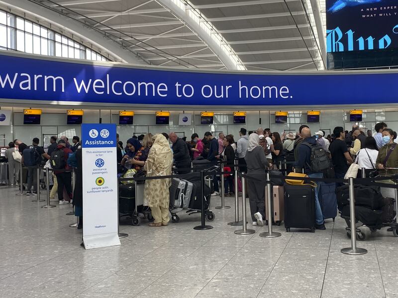 Passengers queue to check-in for a Qatar Airways flight at Heathrow Airport. The UK transport secretary has rejected calls for an emergency visa for aviation workers, industry bosses have claimed. PA