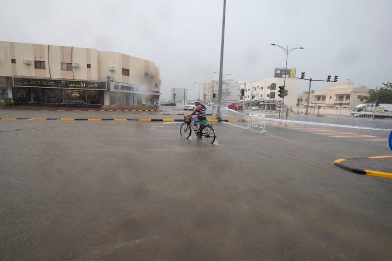 A cyclist struggles to make progress on a flooded road. Ruel Pableo for The National
