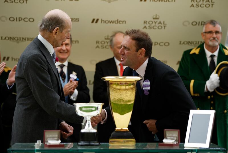Britain's Prince Edward shakes hands with Godolphin trainer Charlie Appleby during the trophy presentation. Reuters