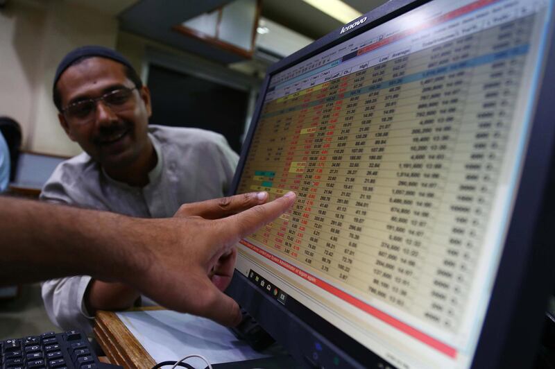 epa07718440 Pakistani stockbrokers monitor the latest share prices during a trading session at the Pakistan Stock Exchange (PSX) in Karachi, Pakistan, 15 July 2019. The benchmark PSX-100 index down 708.91 points at 32,963.58 at the mid-day session.  EPA/SHAHZAIB AKBER