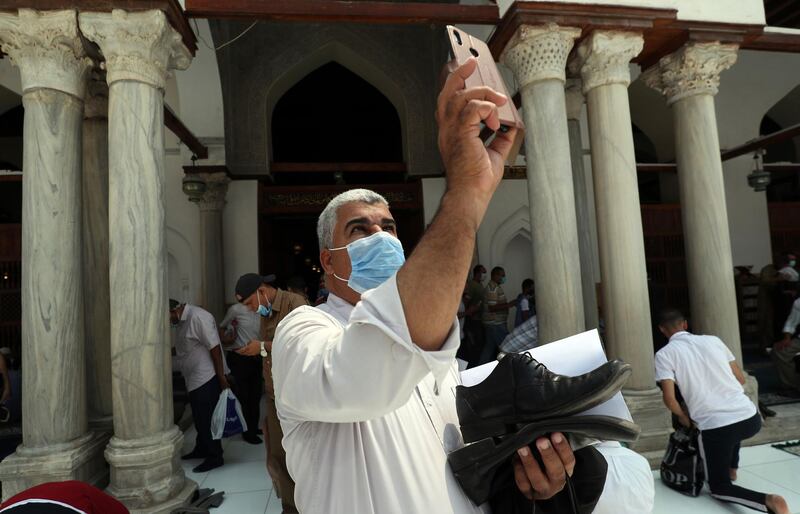 A worshipper takes a selfie as he leaves Al Azhar mosque in Cairo after performing Friday prayers.  AFP