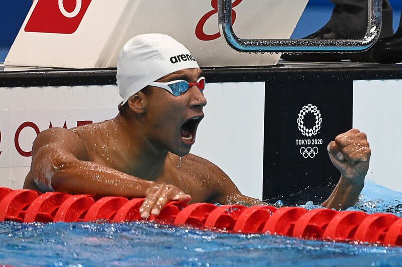 Tunisia's Ahmed Hafnaoui celebrates after winning the final of the Men's 400m Freestyle.