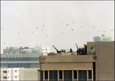 Iraqi soldiers man early 17 January 1991 an anti-aircraft battery on the roof of a building in downtown Baghdad during an allied air raid.  Iraq's invasion of Kuwait 02 August 1990, ostensibly over violations of the Iraqi border, led to the Gulf War which began 16 January 1991. A US-led multi-national force repulsed Iraq from Kuwait and a cease-fire was signed 28 February 1991. (Photo by GERARD FOUET / AFP)