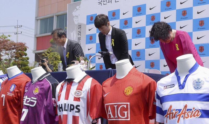 Park Ji-sung, centre, and his parents bow at his news conference on Tuesday announcing his retirement from football. Lee Dong-won / Reuters / News1 / May 13, 2014