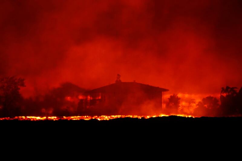 Lava erupts near a home inside Leilani Estates near Pahoa, Hawaii. As lava flows have grown more vigorous in recent days, there's concern more homes may burn and more evacuations may be ordered. Jamm Aquino / Honolulu Star-Advertiser via AP