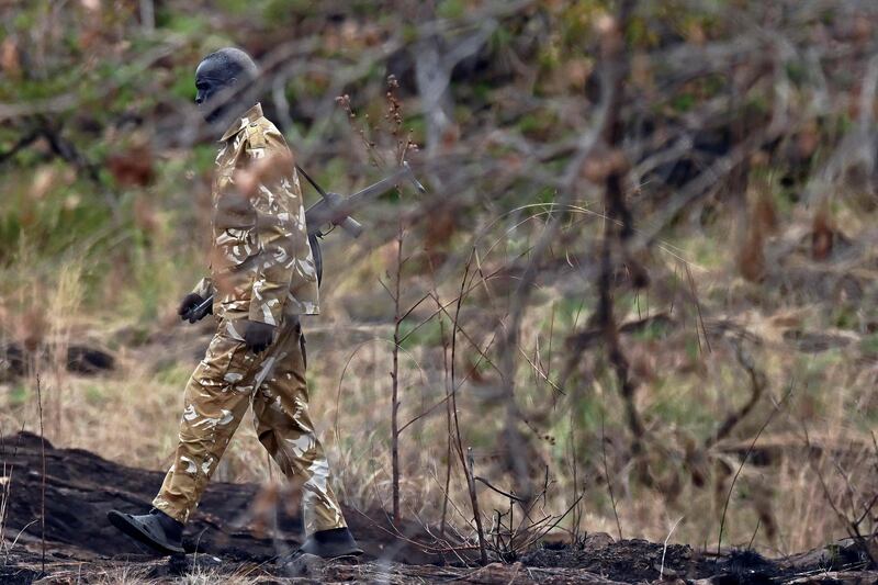 A game warden patrols in sandals at Boma National Park in eastern South Sudan on February 4, 2020. South Sudan holds enormous ecotourism potential, boasting Africa's largest savanna and wetland, the second-largest mammal migration on earth, and the lions, elephants and myriad other endangered and iconic species that have long lured visitors to the continent. / AFP / TONY KARUMBA
