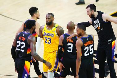 Los Angeles Lakers forward LeBron James walks between celebrating Phoenix Suns players. Reuters