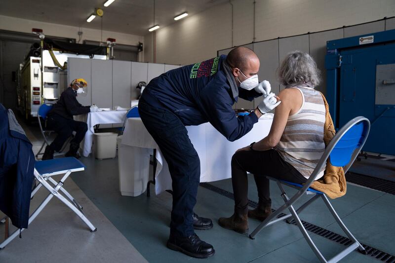 Firefighter/paramedic John Kostyo Jr., administers a Covid-19 vaccination at the Tequesta Fire Department in Tequesta, Florida. AP Photo