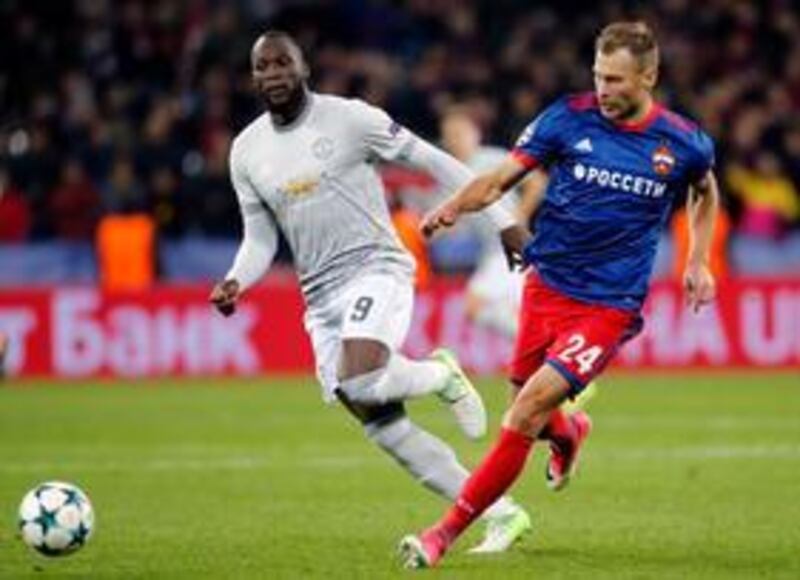 Manchester United's Romelu Lukaku, left, is challenged is challenged by CSKA's Vasili Berezutski during the group A Champions League soccer match between CSKA Moscow and Manchester United, in Moscow (AP Photo/Alexander Zemlianichenko)