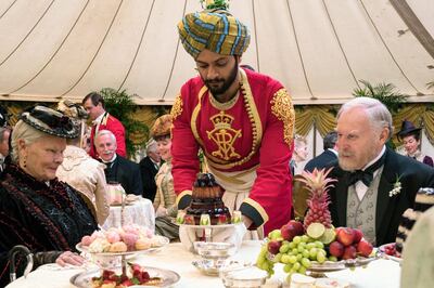 In this image released by Focus Features, Judi Dench, from left, Ali Fazal and Tim Pigott-Smith appear in a scene from "Victoria and Abdul." (Peter Mountain/Focus Features via AP)