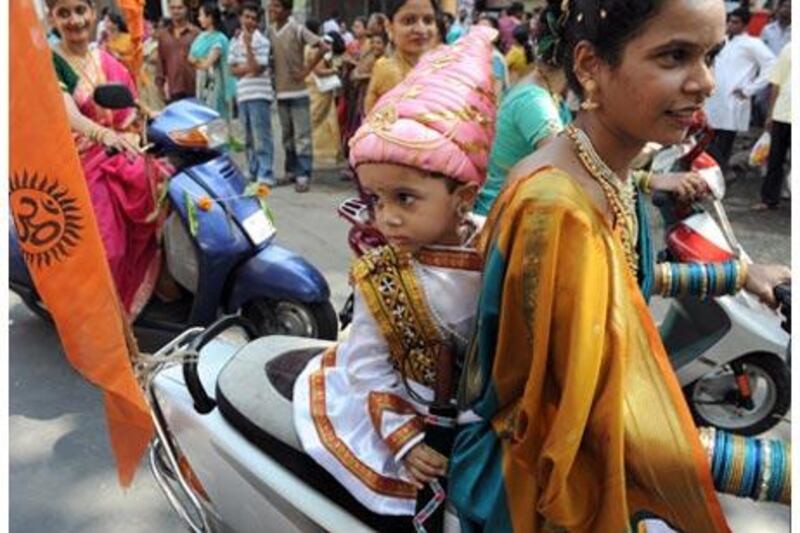 An Indian child dressed as the 17th-century Maratha king Shivaji rides with his mother at a procession to celebrate the Maharashtrian new year in Mumbai.