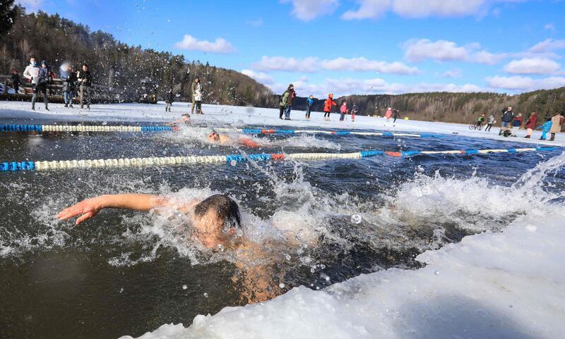 Swimmers compete in an annual winter competition in freezing water, with temperatures outside dropping to -2 degrees Celsius, in Vilnius, Lithuania. AFP