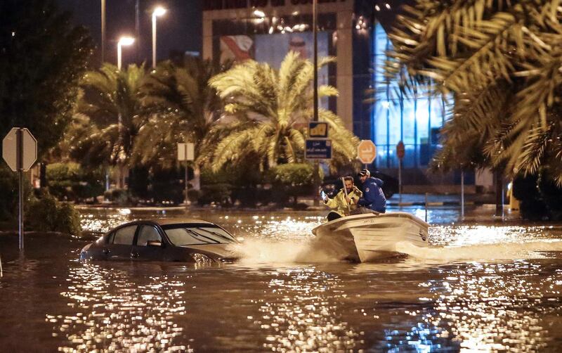 People having fun with a boat on the flooded main road of the Daeya area of Kuwait city. AFP