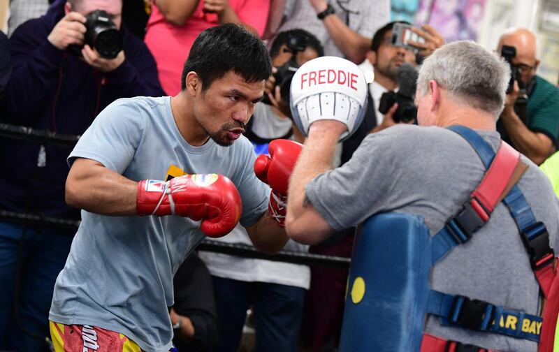 Eight-division world champion boxer Manny Pacquiao spars with coach Freddy Roach. AFP