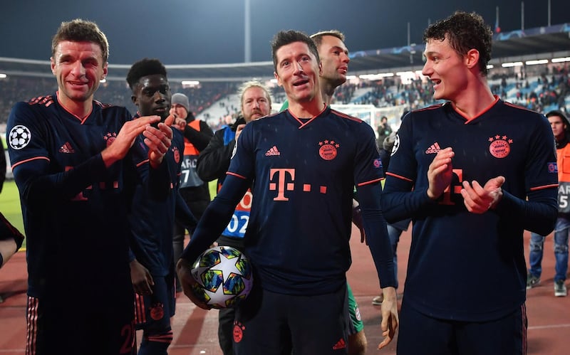 Robert Lewandowski, centre,  celebrates with Thomas Muller, left, and Benjamin Pavard after the match against Red Star. AFP