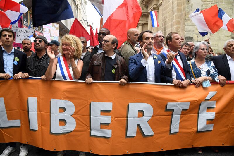 Florian Philippot, fourth right, of French nationalist party The Patriots, and Nicolas Dupont-Aignan, third right, leader of the right-wing Debout la France party, among protesters in Paris.
