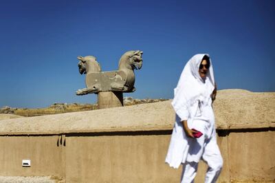 A Spanish tourist walks past an Achaemenid griffin at the ancient Persian city of Persepolis near Shiraz in southern Iran. AFP