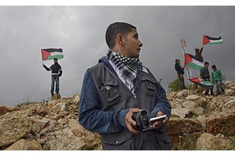 Arafat Kanaan, 17, founder of Ni'lin Media Group, says his camera is like a weapon.