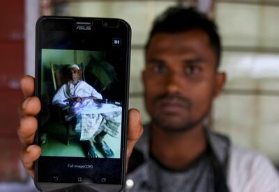 In this Tuesday, Sept. 12, 2017, photo, Rohingya refugee Muhammad Ayub shows off a picture of his grandfather allegedly killed during recent violence in Myanmar, in Klang on the outskirts of Kuala Lumpur, Malaysia. Recent violence in Myanmar has driven hundreds of thousands of Rohingya Muslims to seek refuge across the border in Bangladesh. There are some 56,000 Rohingya refugees registered with the U.N. refugee agency in Malaysia, with an estimated 40,000 more whose status has yet to be assessed. (AP Photo/Daniel Chan)