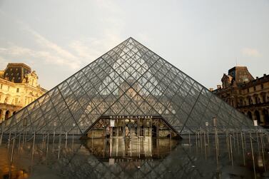 Visitors pass by the pyramid of the Louvre Museum in Paris, France, March 1, 2020. Louvre museum has closed its door to visitors today. TEPA