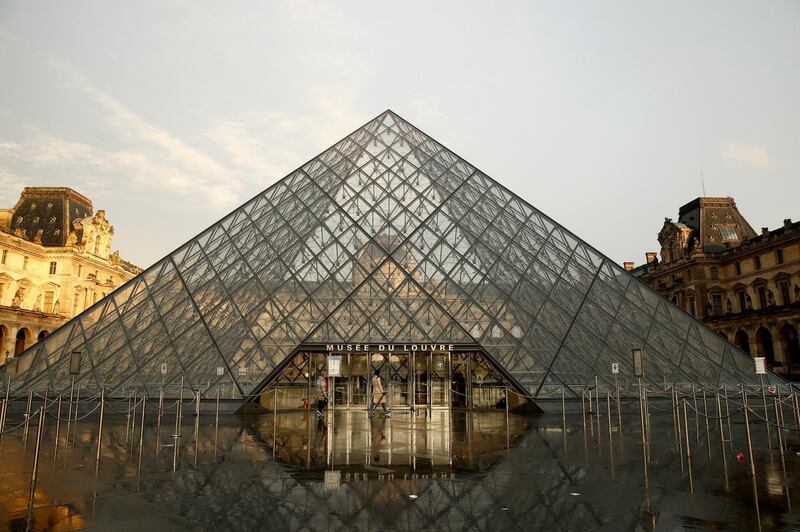 epa08262868 Visitors pass by the pyramid of the Louvre Museum in Paris, France, 01 March 2020. Louvre museum has closed its door to visitors today. The famous museum held a staff meeting about the coronavirus outbreak. Media reports, the museum's employees and guards feared to be contaminated by visitors's flow over  coronavirus epidemic COVID-19 disease.  EPA/YOAN VALAT