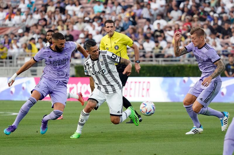 Juventus forward Angel Di Maria dribbles between Karim Benzema and Toni Kroos. AP